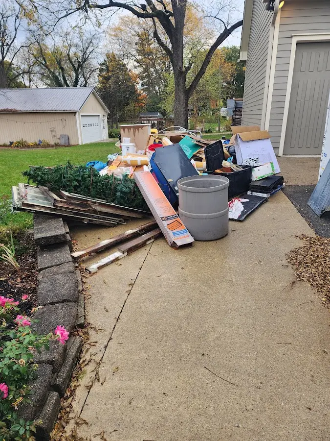 Dumpster being loaded with debris for Roofing Dumpster Rental in Centre